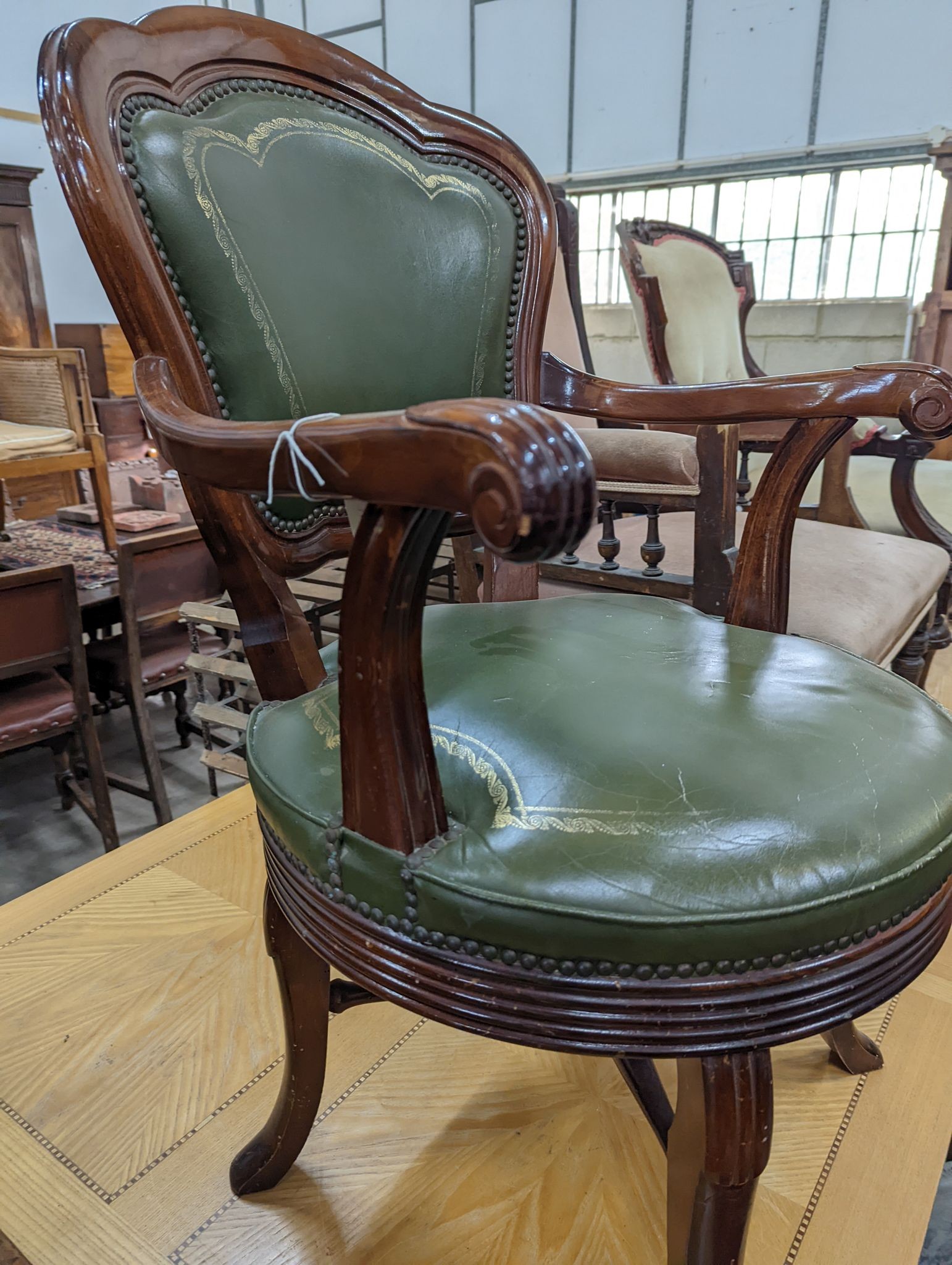 A Victorian style mahogany and green leather swivel desk chair, width 60cm, depth 50cm, height 96cm